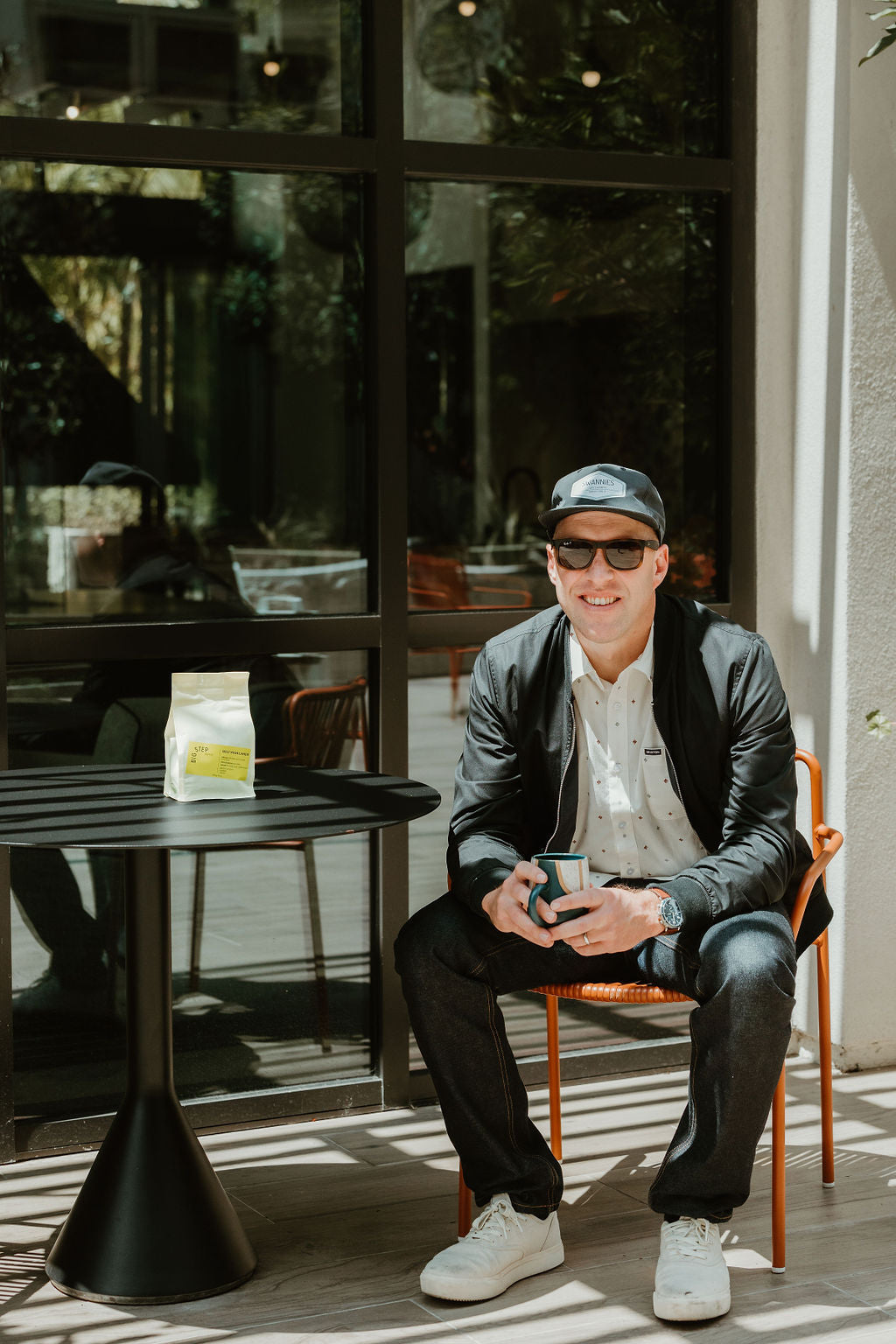 Picture of founder sitting and drinking a coffee